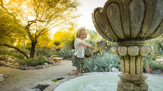 A child plays at a fountain at the Tucson Botanical Gardens. | Photo by Dominic Bonuccelli/Tucson Botanical Gardens